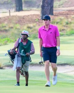 Nick Dunlap and caddie